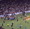 The crowd rushes the field at Allianz Stadium.
