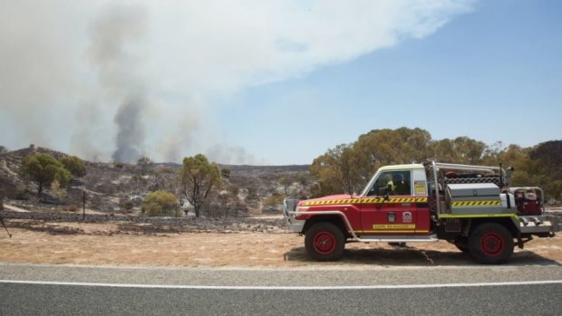 Firies still work to contain a fire burning out of control in Yanchep.