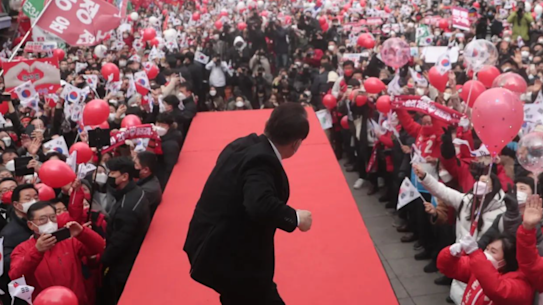 Yoon rallies the crowd in Seoul. 