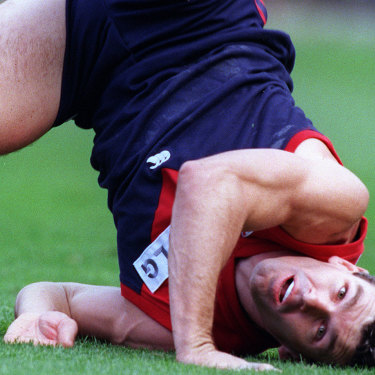 Melbourne’s Shaun Smith, one of the ex-players threatening to sue, hits the ground after attempting a mark in 1998.