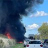 Truck carrying army tank in fiery seven-vehicle crash on highway