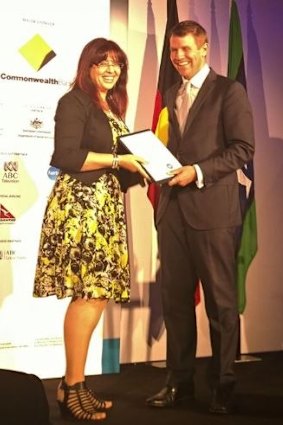 Eman Sharobeem receives her commendation in the Australian of the Year Award from then-NSW premier Mike Baird.