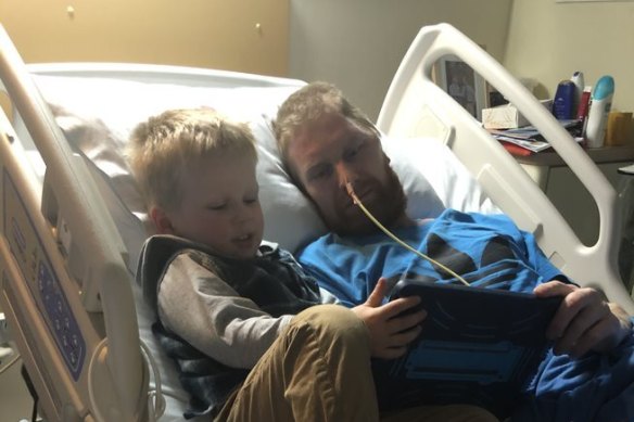 Tim Smith in hospital with son Hudson. 