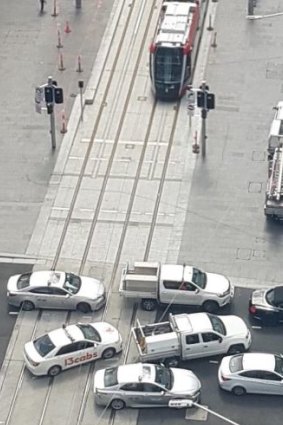 Vehicles block the light rail line at an intersection in Sydney's CBD.