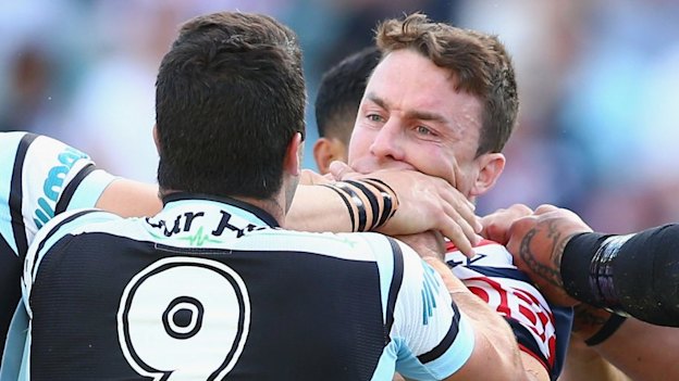 Cronulla’s Michael Ennis and Roosters’ James Maloney (both right) scuffle in 2015, one season before becoming Sharks teammates.