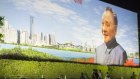 People sit near a portrait of China’s former leader Deng Xiaoping in Shenzhen.