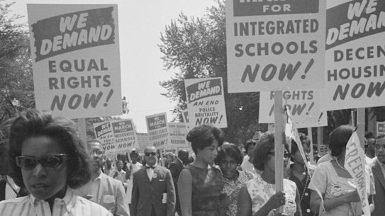 Same old story ... context is everything. Black Americans carry signs for equal rights, integrated schools, decent housing, and an end to bias in the early 1960s. 
