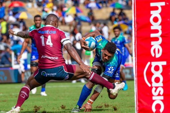 Reds winger Suliasi Vunivalu (left) trips Fijian Drua’s Kitione Salawa during Queensland’s loss in Suva.