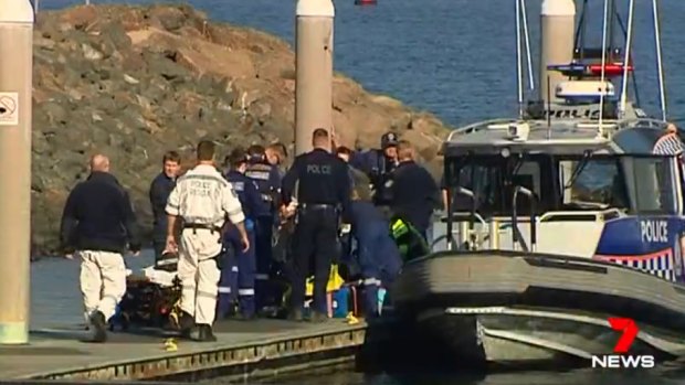 Emergency services attempt to rescue rock fisherman at Cape Banks. 