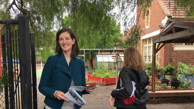 Ellen Sandell handing out how to vote cards at North Melbourne Primary School.