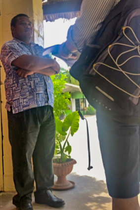 Kiribati’s Principal Immigration Officer Uering Iteraera stands guard at 60 Minutes’ hotel.