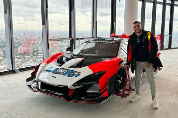 Adrian Portelli poses with the sports car he hoisted into his apartment.