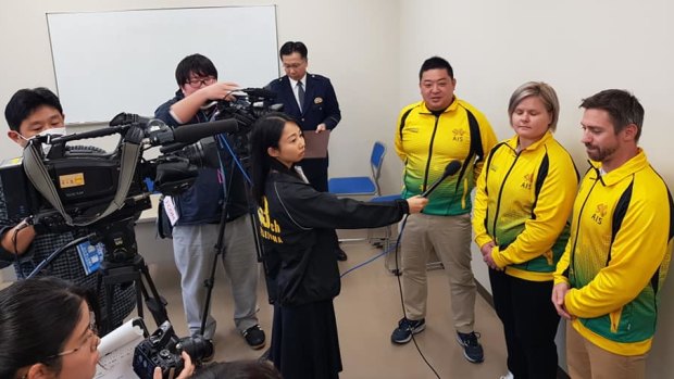Heroes: Judo coaches Hitoshi Kimura, Kylie Koenig and Ben Donegan interviewed by local media after receiving their letters of appreciation from Japanese police.