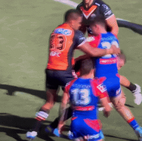 Jackson Hastings and Joe Ofahengaue lift Newcastle’s Tex Hoy into a dangerous position in 2022.