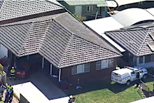 Two women fighting for life after colliding with police car and slamming into a Bossley Park home.