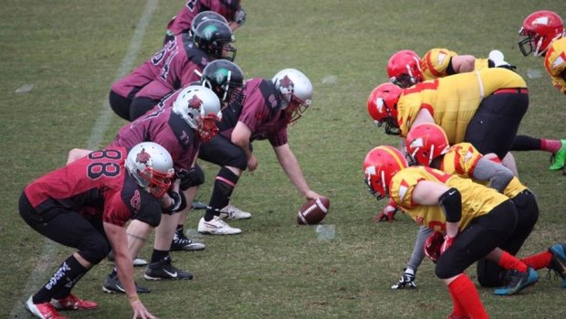 Barbarians line up against the Firebirds in the ACT Gridiron competition.