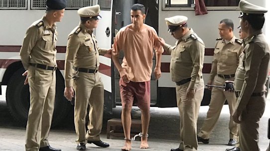Hakeem Al-Araibi arrives at the Bangkok court on Monday with his legs shackled.