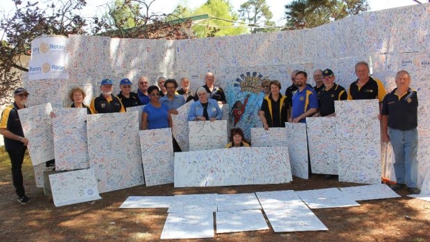 Rotary District 9710 members with the massive 90th birthday card signed by 11,515 people at its Floriade marquee.