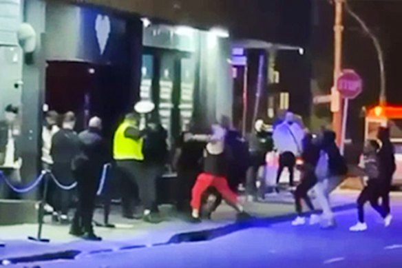A fight between different factions of the Comancheros outside Love Machine. 