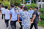 An injured student is carried by Coast Guard personnel and other students as they provide assistance for earthquake victims at a school in Sta Cruz in the Davao del Sur province.