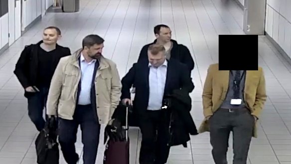 Four Russian officers are escorted to their flight after being expelled from the Netherlands on April 13, 2018, for allegedly trying to hack into the chemical watchdog OPCW's network. 