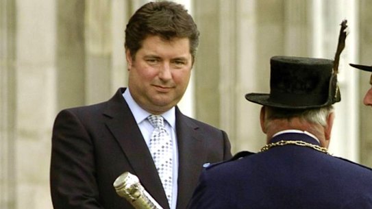 A 2004 file photo shows Michael Fawcett, left. the former close aide to Britain’s Prince Charles stepped down temporarily from his role as chief executive of a royal charity amid reports that he helped secure an honour for a Saudi donor.