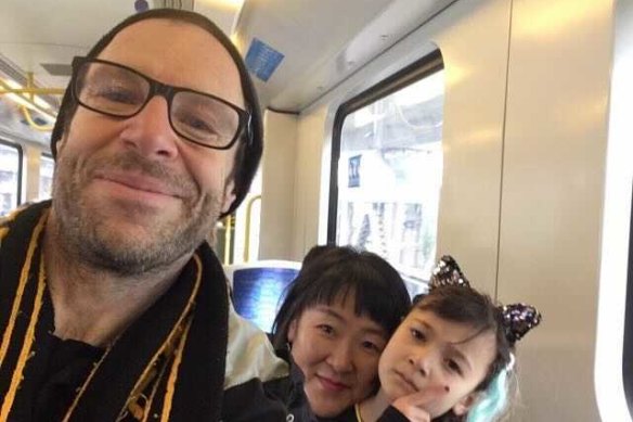 Tigers fan Kevin Passmore, his partner Jin ah Jo and daughter Ara on their way to the 2019 grand final. 