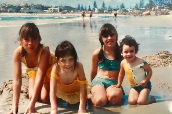 Kathy Lette, left, and her sisters Liz, Jenny and Carolyn on the beach in the 1960s. 