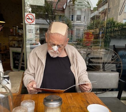 On the road to recovery: Ross Gittins enjoying a trip to the cafe after being released from hospital. 