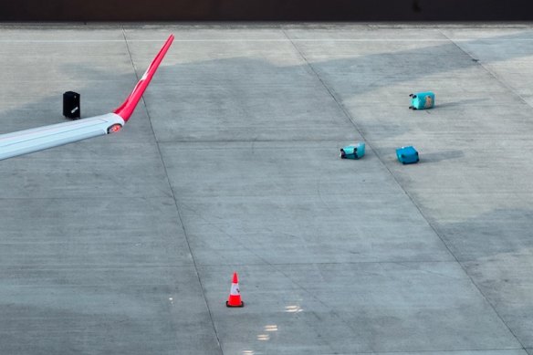 One reader spotted a bunch of bags strewn all over the tarmac at Sydney Airport.