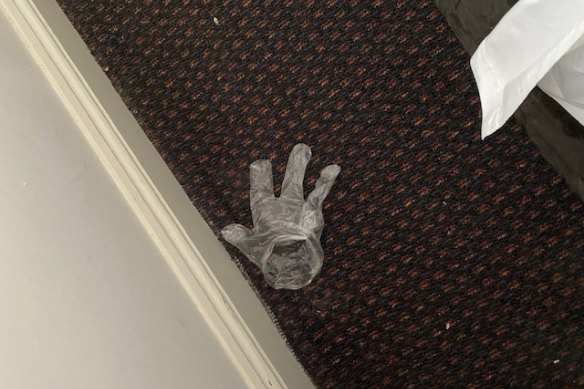 A discarded glove Mr de Kretser found on the floor of his dirty hotel room.