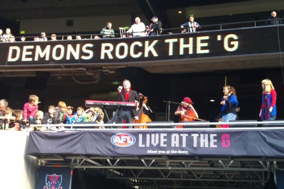David Bridie singing at the MCG before a Melbourne game.