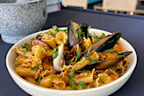 Gigli is a small, fluted dried pasta rolled in the shape of a cone or flower with ruffled edges.