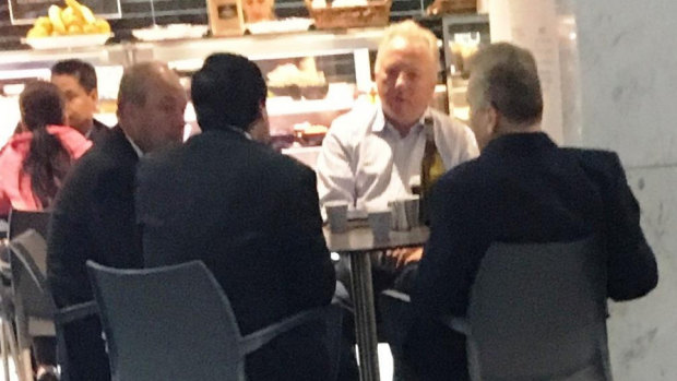 Daryl Maguire, left, with Charbel Demian, (second from left with back to camera), an unknown male referred to as Ron (white shirt) and Michael Hawatt (right, back to camera) at a Sydney café. 