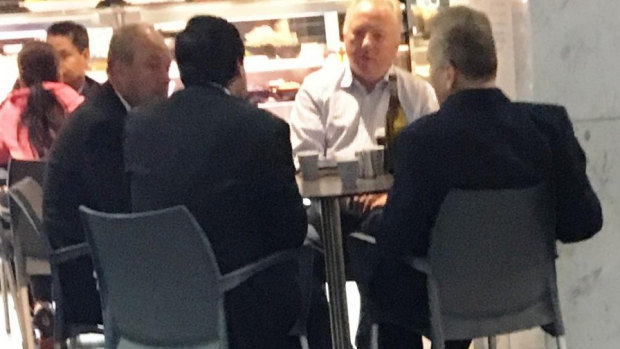 Daryl Maguire, left, with Charbel Demian, (second from left with back to camera), an unknown male referred to as Ron (white shirt) and Michael Hawatt (right, back to camera) at a Sydney café. 