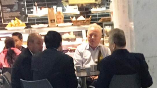Daryl Maguire, left, with Charbel Demian, (second from left with back to camera), an unknown male referred to as Ron (white shirt) and Michael Hawatt (right, back to camera) at a Sydney café. 