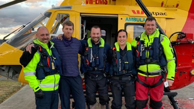Michael Bowman, 57, is pictured with rescue crews on Tuesday afternoon.