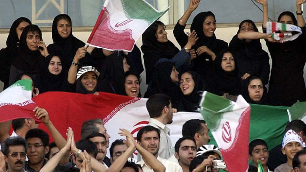 A too-rare sight ... Iranian women cheer their national team in an Asian World Cup qualifying match against Bahrain in 2006. Now women resort to disguising themselves as men to enter stadiums.