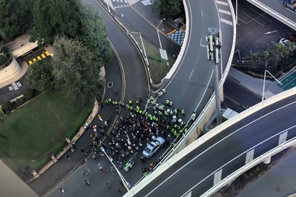 Queensland police form a barricade to keep protesters away from traffic.