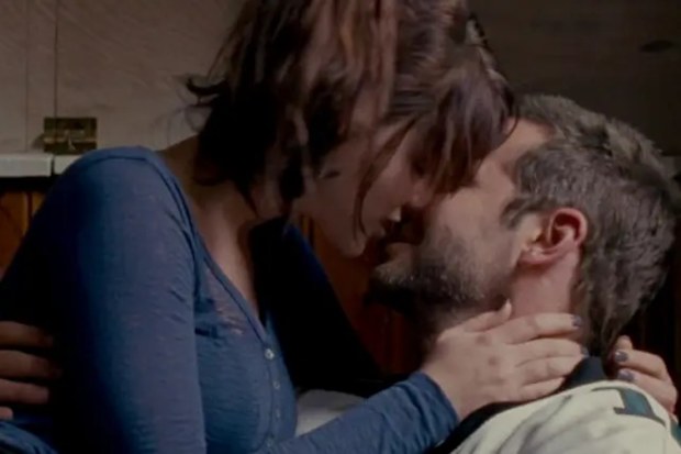 Jennifer Lawrence and Bradley Cooper kiss in a scene from the 2012 movie Silver Linings Playbook.