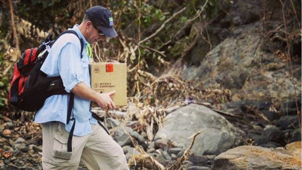 Rob Cardwell treks through bushlands and creeks to deliver aid and supplies to a village in Fiji. 