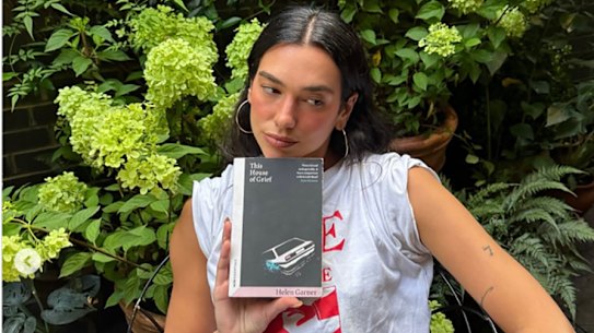 Dua Lipa poses with Helen Garner’s 2014 book.