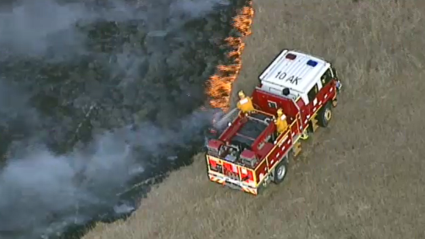 Emergency services are at the scene of a grassfire in Mernda. 
