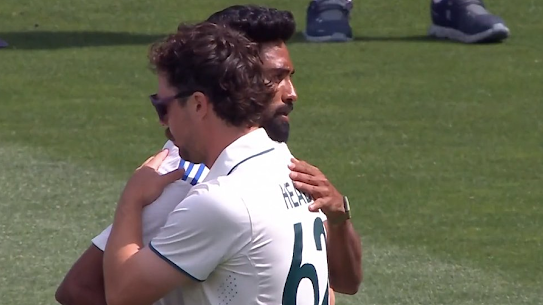Travis Head and Mohammed Siraj embrace after the Adelaide Test.