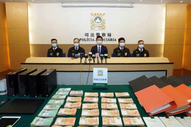 Computers, mobile phones and cash on display after the Chau arrest.