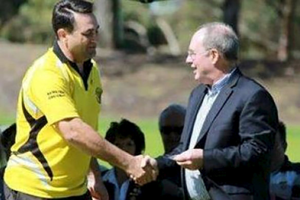 Bradley Edwards receiving a community award prior to his arrest from then-deputy premier Eric Ripper. 