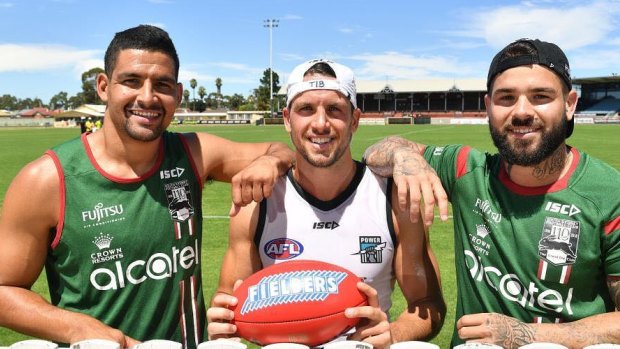 Valuable tips: Cody Walker, left, and Adam Reynolds with Port Adelaide's Travis Boak.