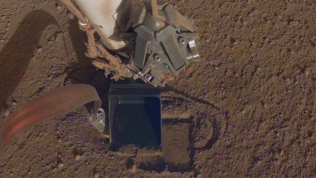 InSight's heat probe digging into the surface of Mars. 