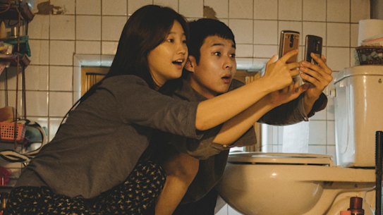Searching for free Wi-Fi: Park So-dam and Choi Woo-shik in Parasite. 