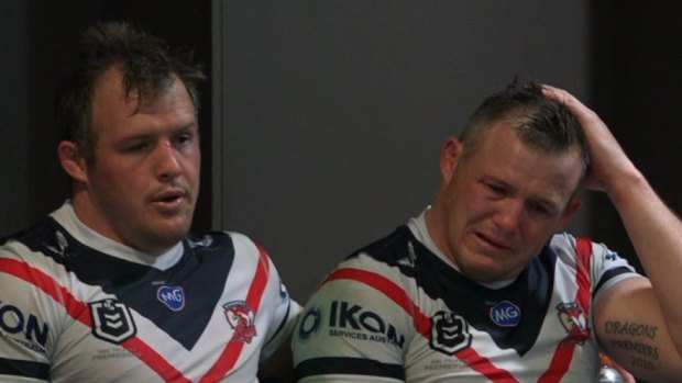 Inconsolable: Brett Morris with brother Josh in the rooms after the Knights match.